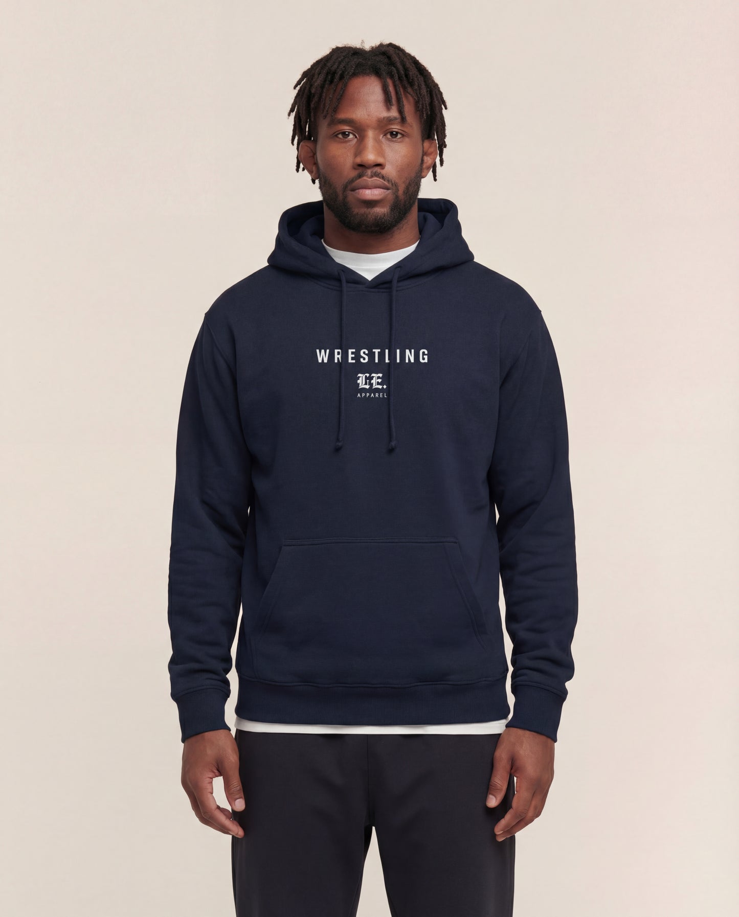 Man wearing a Navy hoodie with 'Wrestling' text on a beige background